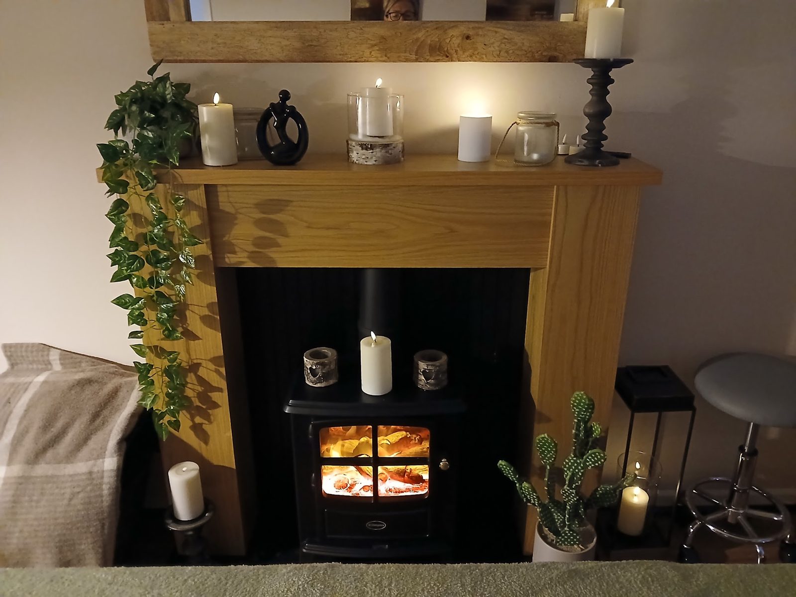 The fireplace with candles and trailing plants